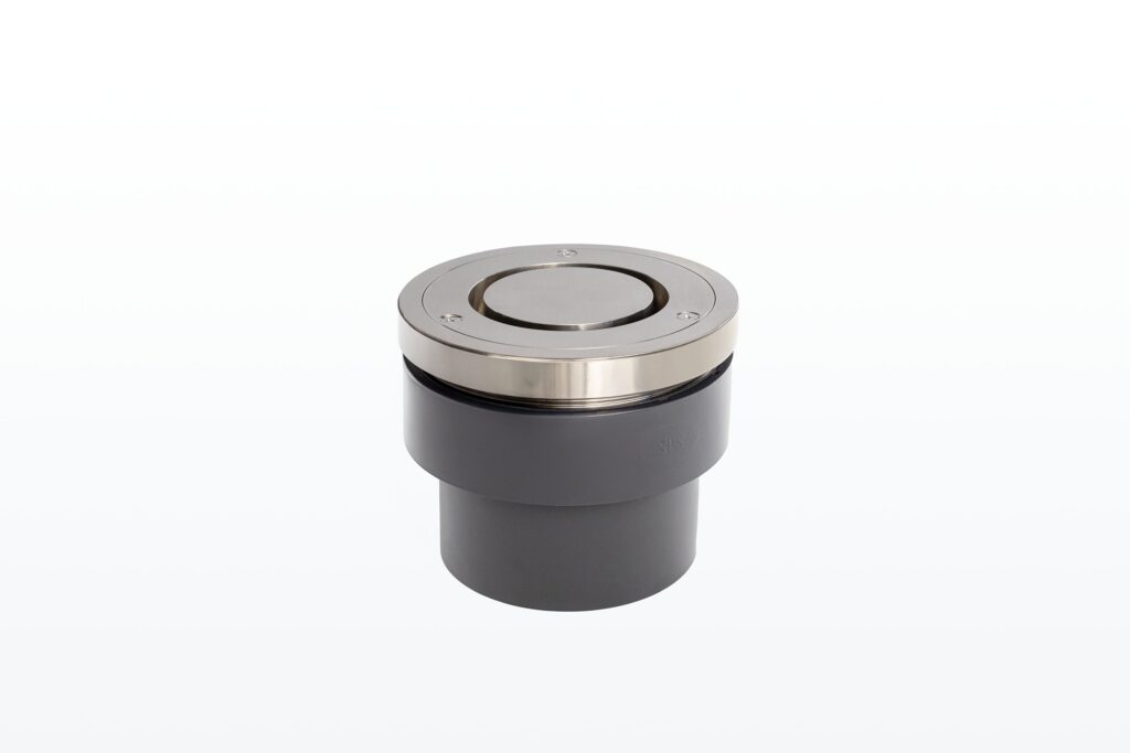 A cylindrical, metallic pressure fitting with a silver top and a dark grey body, set against a plain white background.