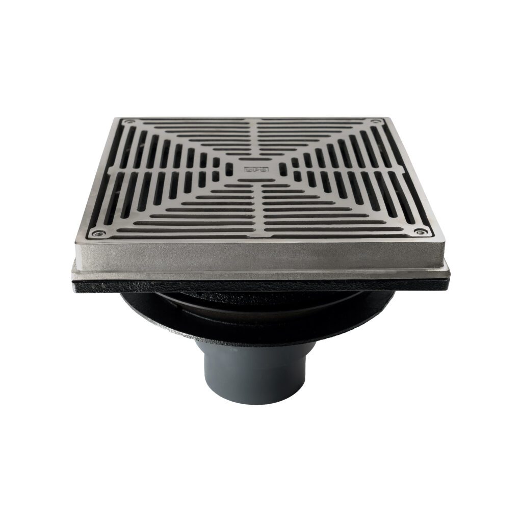 A square metal floor drain with a slotted grate cover, mounted on a round black base and pipe, shown against a white background.